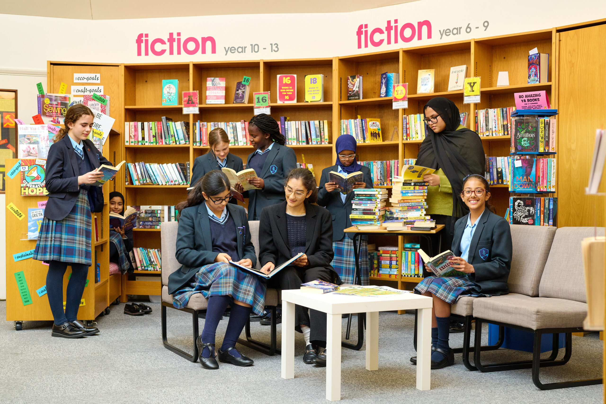 a group of girls reading in the library